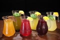 Cold compotes in large glass jars. Summer fruit drinks in glass jugs. Cold lemonades. Lemonade. Morse. Compote. Royalty Free Stock Photo