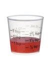 Cold or cough syrup medicine in a measuring cup isolated on whit Royalty Free Stock Photo