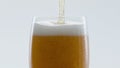 Cold craft beer pouring to glass in super slow motion close up. Drink foaming. Royalty Free Stock Photo