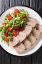 Cold cuts of beef tongue served with fresh salad closeup at plate. vertical top view Royalty Free Stock Photo