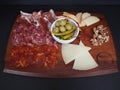 Cold Cuts Cheese Platter served in a dish isolated on dark background top view Royalty Free Stock Photo