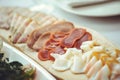 Cold cuts with ham, bacon, salami and bacon on a light background. Meat platter Royalty Free Stock Photo