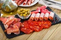 Cold cuts from ham, bacon, sausages on slate plate