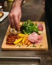 Cold cuts: Salami, Chorizo, Pepperoni and meats served with cheese, vegetable salad, red wine and cut toasts. Royalty Free Stock Photo