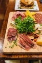 Cold cuts: Salami, Chorizo, Pepperoni and meats served with cheese, vegetable salad, red wine and cut toasts. Royalty Free Stock Photo