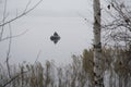 On a cold day in winter, a fisherman on an inflatable boat catches fish Royalty Free Stock Photo