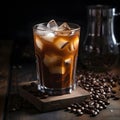 Cold drink with espresso and tonic in glass on black background. Cold espresso coffee tonic in a glass with ice on a wooden table