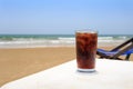 A cold drink in a glass on the beach,