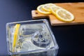 Cold drink in a glass on the kitchen table. Lemon and ice with water the best way to cool off on a summer day Royalty Free Stock Photo