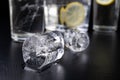 Cold drink in a glass on the kitchen table. Lemon and ice with water the best way to cool off on a summer day Royalty Free Stock Photo