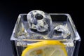 Cold drink in a glass on the kitchen table. Lemon and ice with water the best way to cool off on a summer day Royalty Free Stock Photo