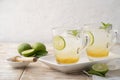 Cold drink,lime juice with mint honey and ice cube in a glass on white wooden rustic background Royalty Free Stock Photo