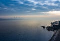 Cold early winter morning, light haze and fog rise above the calm water of the river, on the shore there are trees without leaves. Royalty Free Stock Photo