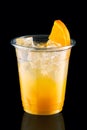 Cold fizz cocktail with orange in take away cup isolated on black Royalty Free Stock Photo