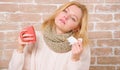 Cold and flu symptoms. Sick woman with sore throat drinking cup of warm tea. Pretty girl with nasal cold suffering from