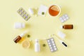 Cold and flu treatment set. Pills, throat spray, medical mask, thermometer, recipe on simple yellow background. Health care