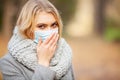 Cold and flu. Woman with a medical face mask at outdoor Royalty Free Stock Photo