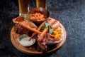 Cold Foamy Golden Chilled Glass of Draft Beer Served with Delicious Hot Crispy Homemade Fresh Fried Plate in Chicken Wings, Sliced