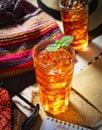 Cold fragrant tea in a glass on the original napkin, mint leaves Royalty Free Stock Photo