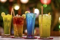 Cold and fresh alcoholic beverages in an exotic restaurant garnished with lemon piece and ecofriendly wooden straw with bokeh