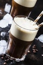 Cold frothy frappe coffee in large glasses on brown background,