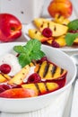 Cold fruit soup with raspberry, grilled nectarines, ice cream, vertical Royalty Free Stock Photo