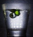 Cold glass with balls falling