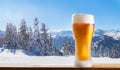 Cold glass of beer on a wooden table against winter landscape