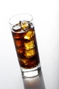 Cold glass of cola drink with ice cubes isolated on white background Royalty Free Stock Photo