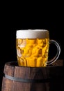 Cold glass of craft beer on old wooden barrel Royalty Free Stock Photo