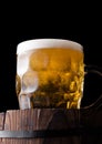 Cold glass of craft beer on old wooden barrel Royalty Free Stock Photo