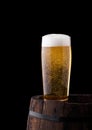 Cold glass of craft beer on old wooden barrel Royalty Free Stock Photo