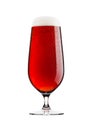 Cold glass of red bitter beer with foam and dew Royalty Free Stock Photo
