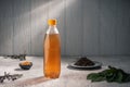 Cold green tea next to tea leaves in a steamed plastic bottle Royalty Free Stock Photo