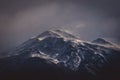 Cold grey clouds over a rugged mountain Royalty Free Stock Photo