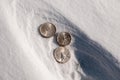 Cold hard cash - silver coins in snow Royalty Free Stock Photo