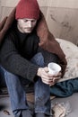 Cold and homeless man begs for money Royalty Free Stock Photo