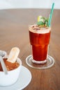 Cold iced tea with lemon slice and mint in glass on wood table Royalty Free Stock Photo