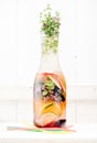 Cold Infused Detox Water Summer lemonade with berries, herbs and fruits in a glass bottle