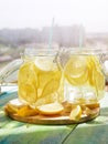 Cold Lemonade ice, in jugs, straw, urban view Royalty Free Stock Photo