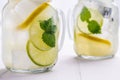 Cold Lemonade with Ice. Lemon and Mint Leaves in Mason Jar on Dark Wooden Background. Royalty Free Stock Photo