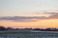 Cold Lithuanian winter. The fields are illuminated by the sunset.