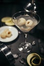 Cold lychees martini on a dark wooded surface
