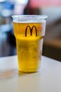 Cold Mahou beer in a plastic cup with McDonald logo. Beer served in Spanish McDonald. Royalty Free Stock Photo