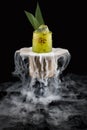 Cold mango lemonade surrounded by smoke on a dark background Royalty Free Stock Photo
