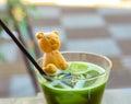 Cold Matcha Green Tea Drink with a waffle bear