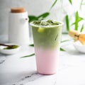 Cold matcha latte in a tall glass on marble