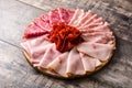 Cold meat on cutting board on wooden table. Ham, salami, sausage mortadella and turkey Royalty Free Stock Photo