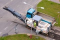 Cold milling machine removing asphalt pavement for repairing the road.