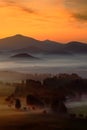 Cold misty foggy morning with sunrise in a fall valley of Bohemian Switzerland park. Hills with fog. Landscape of Czech Republic. Royalty Free Stock Photo